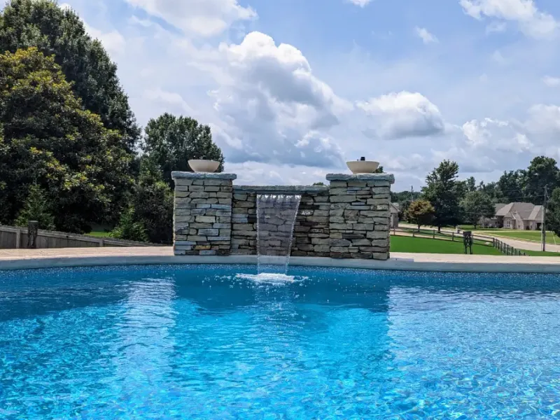 Pool installation with a natural stone with waterfall.