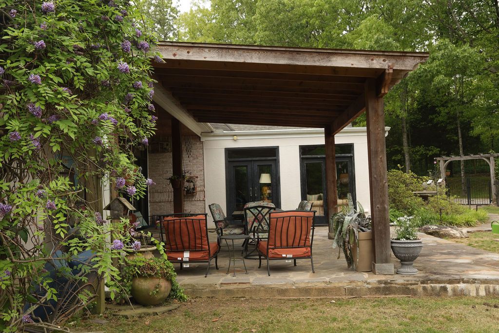 Extended outdoor patio with wood beams.